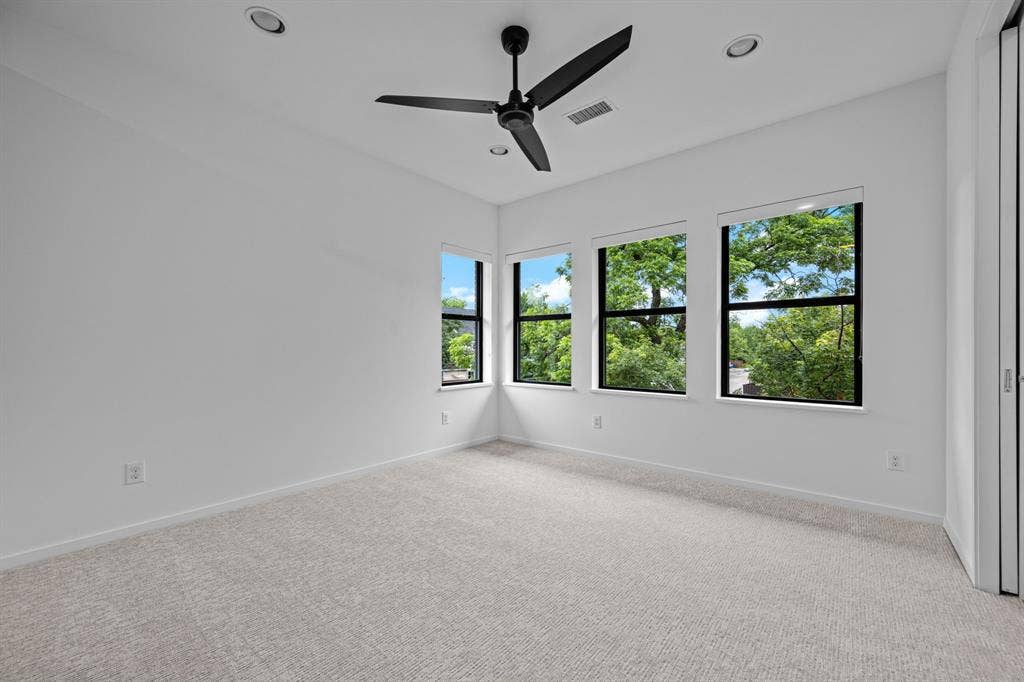 Treetop views and fresh carpet make this upstairs bedroom an inviting personal retreat.