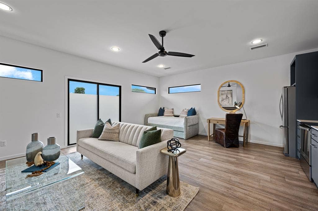An open studio layout accommodates lounging, sleeping, and working beneath windows that invite natural light.