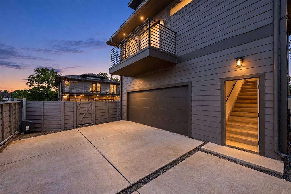 Flexibility beyond the main house: a two-car garage with a separate entrance to the upstairs guesthouse, complete with its own kitchen, full bath, and laundry.