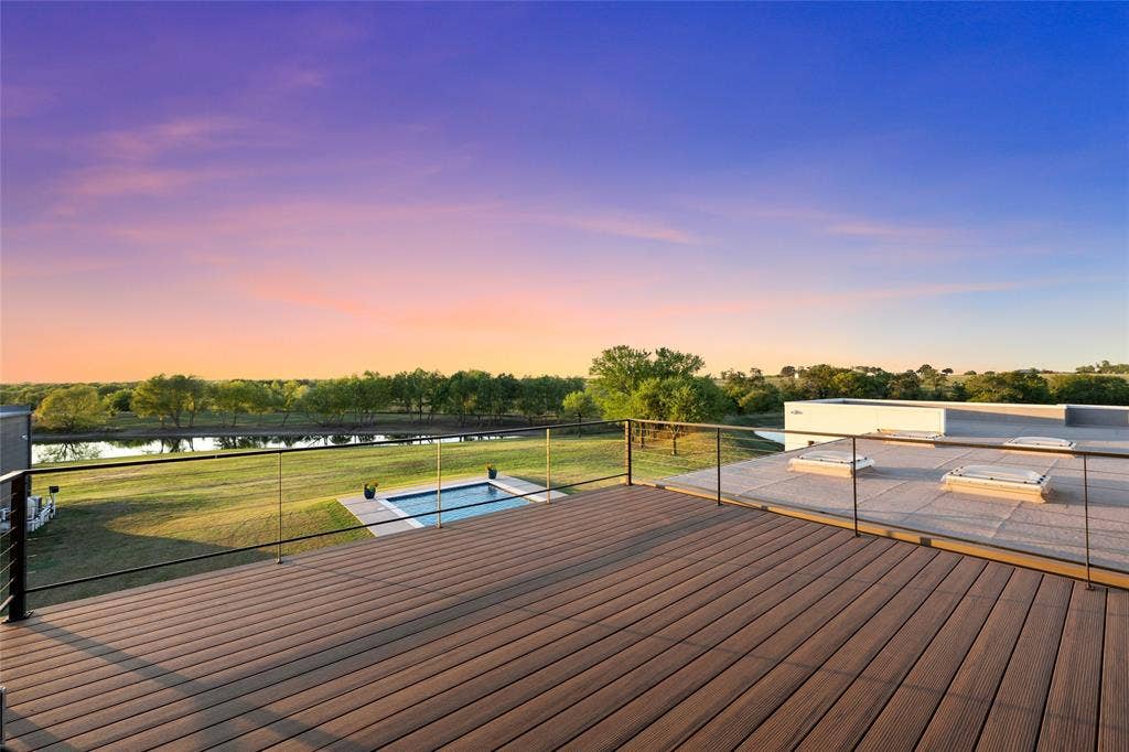 356 Bold Springs Court, West, TX 76691 Elevated deck featuring composite wood-finish decking and a cable railing system, overlooking a private swimming pool, pond, and expansive acreage