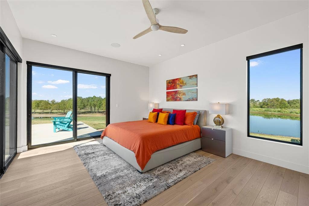 356 Bold Springs Court, West, TX 76691 Wood flooring, expansive sliding glass patio doors, recessed lighting, ceiling fan, and large windows with panoramic views