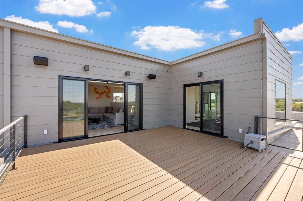 356 Bold Springs Court, West, TX 76691 Rooftop terrace featuring horizontal siding, composite decking, metal cable railings, and dual sliding glass door entryways to Den and Exercise room.
