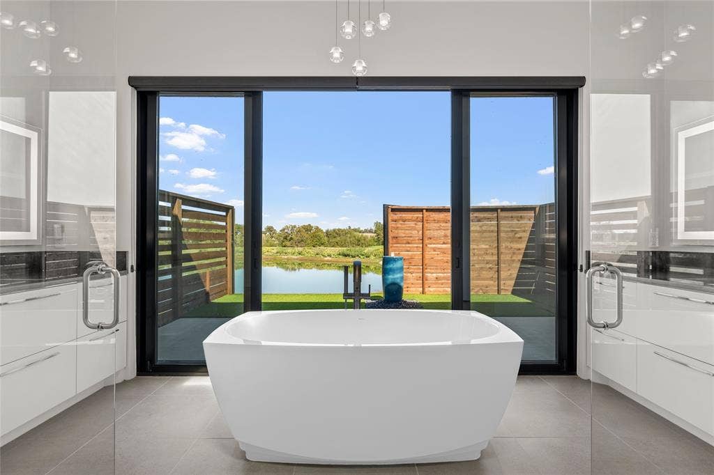 356 Bold Springs Court, West, TX 76691 Freestanding Cryometric soaking tub, expansive glass sliding doors, high-gloss cabinetry, and 24 inch ceramic tile flooring