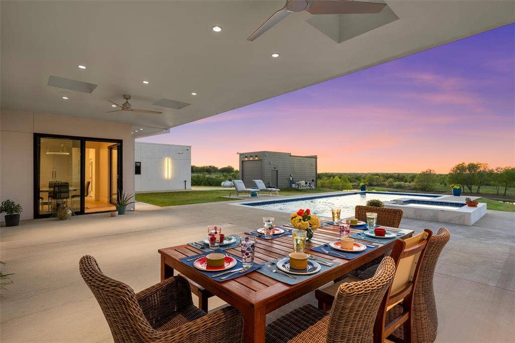 356 Bold Springs Court, West, TX 76691 Covered patio featuring recessed lighting. skylights and ceiling fans, inground pool with an integrated spa and water features, and expansive landscape