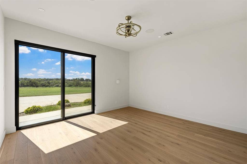 356 Bold Springs Court, West, TX 76691 Guest room/studio/office featuring wood flooring, sliding glass doors with own private entrance, custom ceiling fan surround sound, and recessed lighting