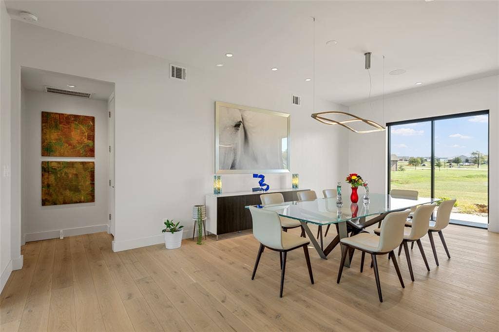 356 Bold Springs Court, West, TX 76691 Wood flooring, recessed lighting, modern geometric fixture, and large-format sliding glass doors
