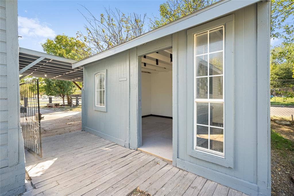 2005 Tisinger Avenue, Dallas, TX 75228 Outbuilding featuring wood-plank siding, an integrated covered porch, a tall multi-pane window, and an open entry
