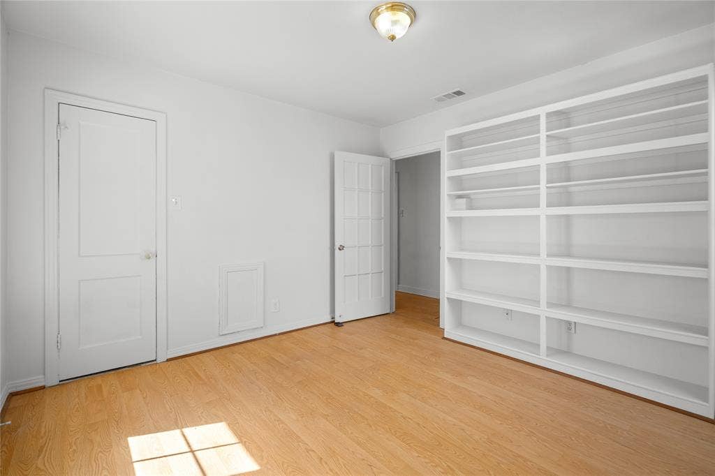 2005 Tisinger Avenue, Dallas, TX 75228 Built-in floor-to-ceiling shelving, wood-finish flooring, two-panel interior door, multi-lite glass door, and flush-mount ceiling light fixture