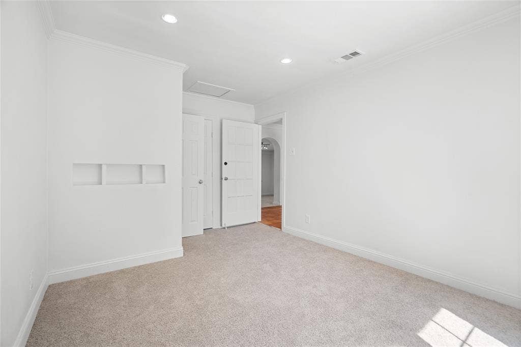 2005 Tisinger Avenue, Dallas, TX 75228 Neutral-toned carpeting, recessed ceiling lighting, crown molding, and a built-in recessed wall niche