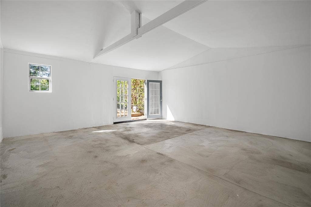 2005 Tisinger Avenue, Dallas, TX 75228 Vaulted ceilings with exposed structural beam, concrete flooring, and French door entry