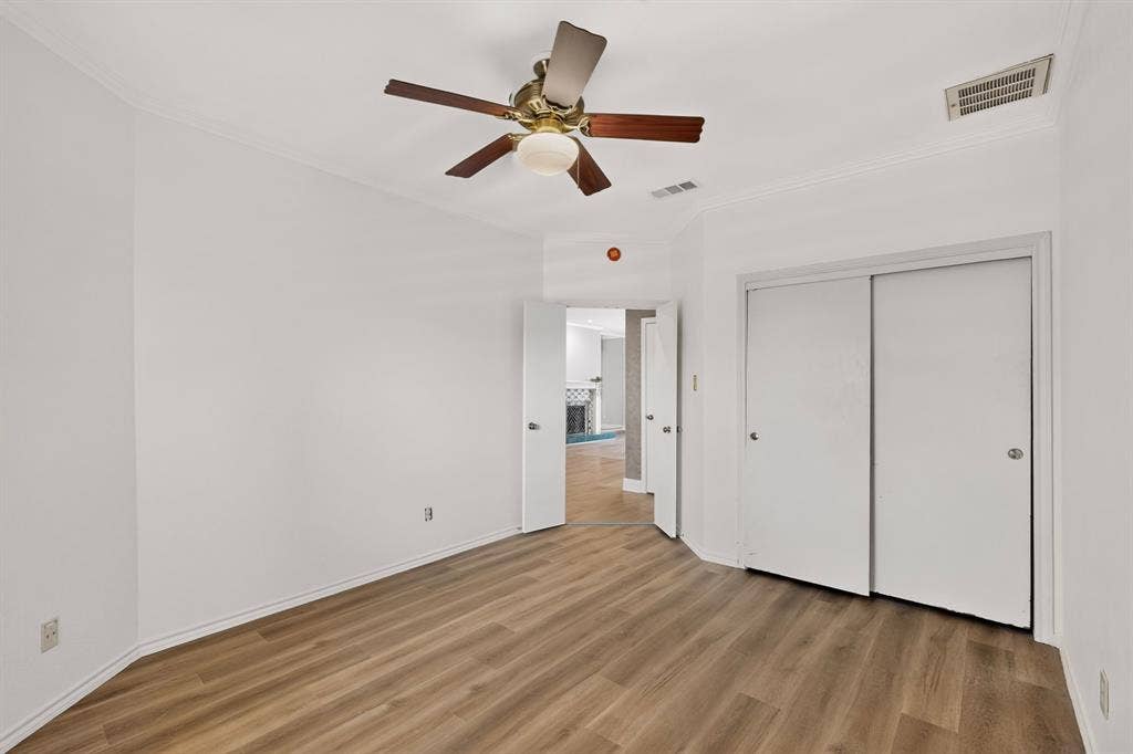 Fresh paint and newly installed flooring in the second bedroom.
