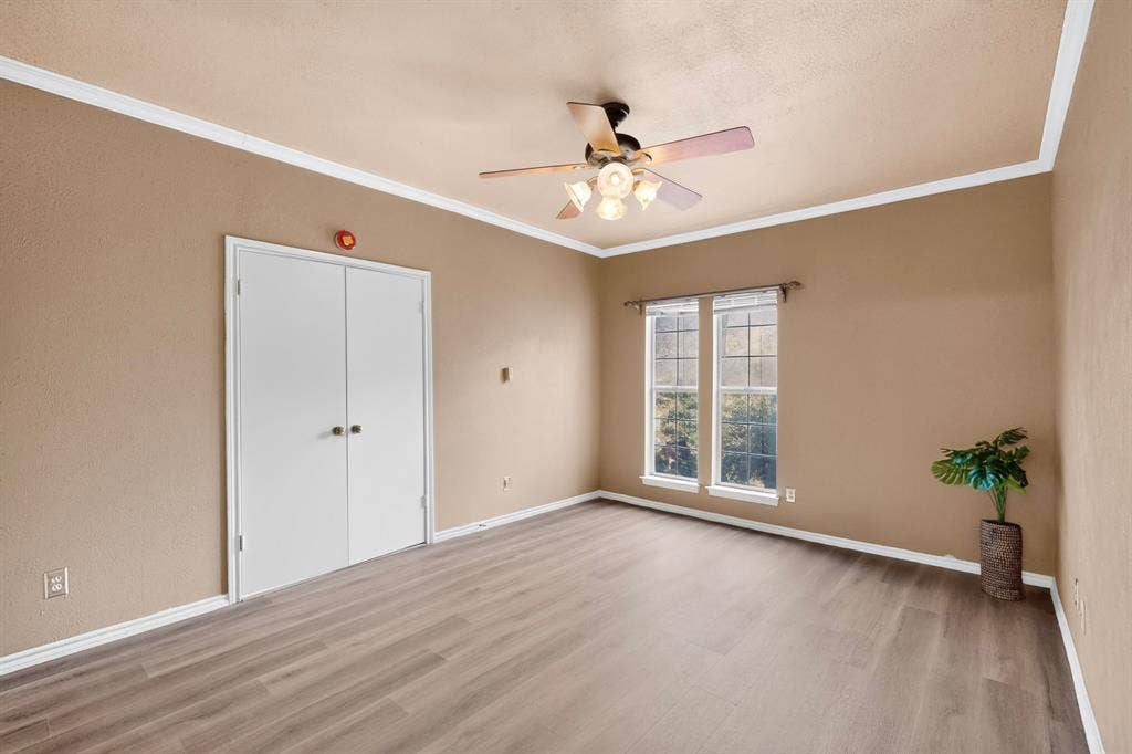 Double doors between the primary bedroom and living area create a stately suite.