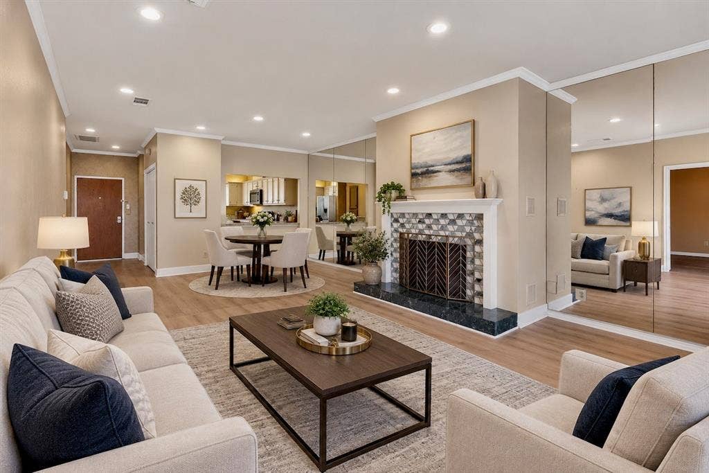 Virtually staged – Envision the life you want in this warm, inviting open-concept condo with recessed lighting, laminate flooring through out, and beautiful modern tiled fireplace.