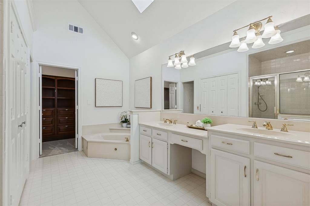 Large primary suite includes large bathroom and closet with custom organization