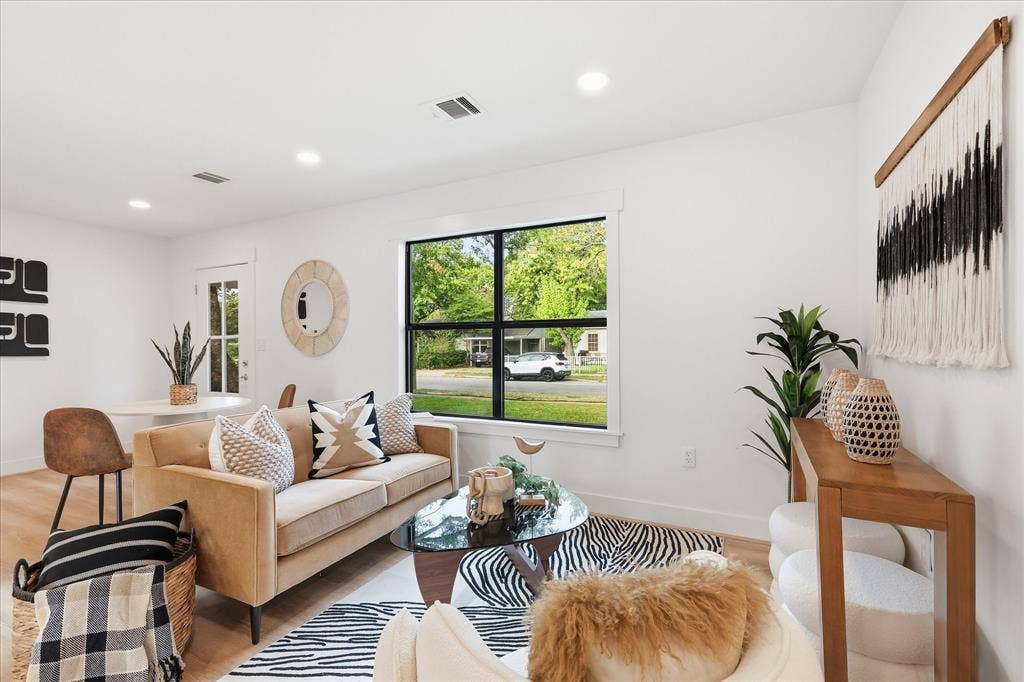 11624 Rupley Lane, Dallas, TX 75218 Bright living area featuring wood-finish flooring, recessed lighting, and a large window with black frame detailing