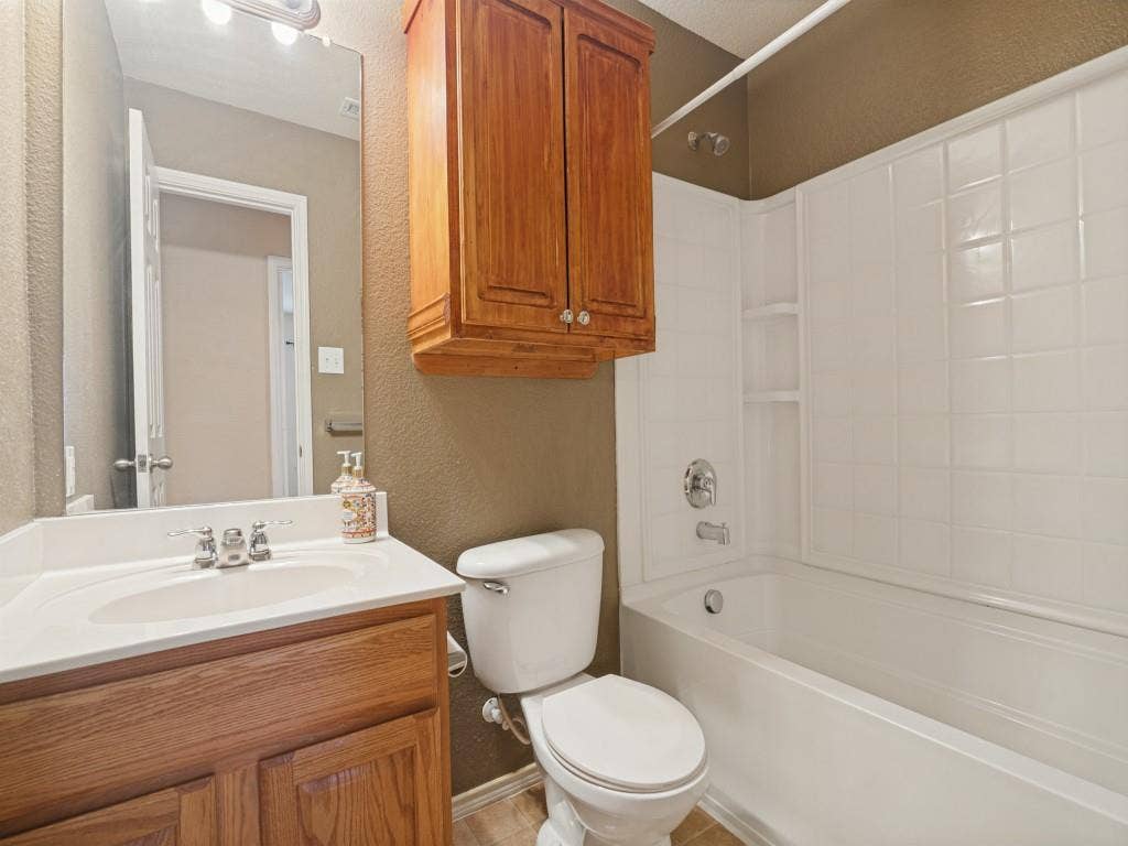 Full secondary bathroom with tub-and-shower combination.