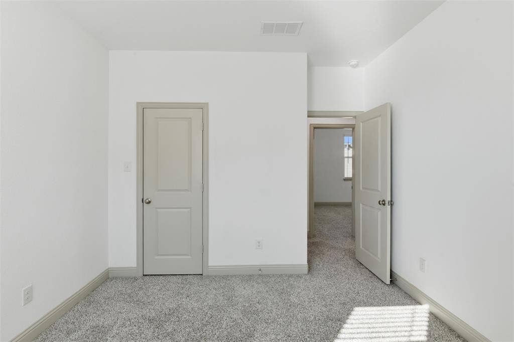 3125 Lucia Way, Princeton, TX 75407 Neutral interior space featuring high-pile wall-to-wall carpeting, two-panel interior doors, and a neutral paint palette
