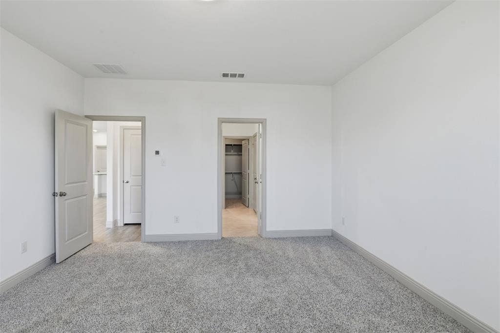 3125 Lucia Way, Princeton, TX 75407 Neutral wall paint, high-pile carpeting, and solid-core interior doors with coordinating trim