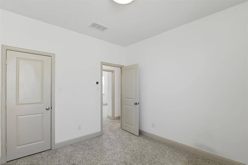3125 Lucia Way, Princeton, TX 75407 Neutral-toned interior space featuring wall-to-wall carpeting, white walls, and two-panel interior doors with brushed nickel hardware