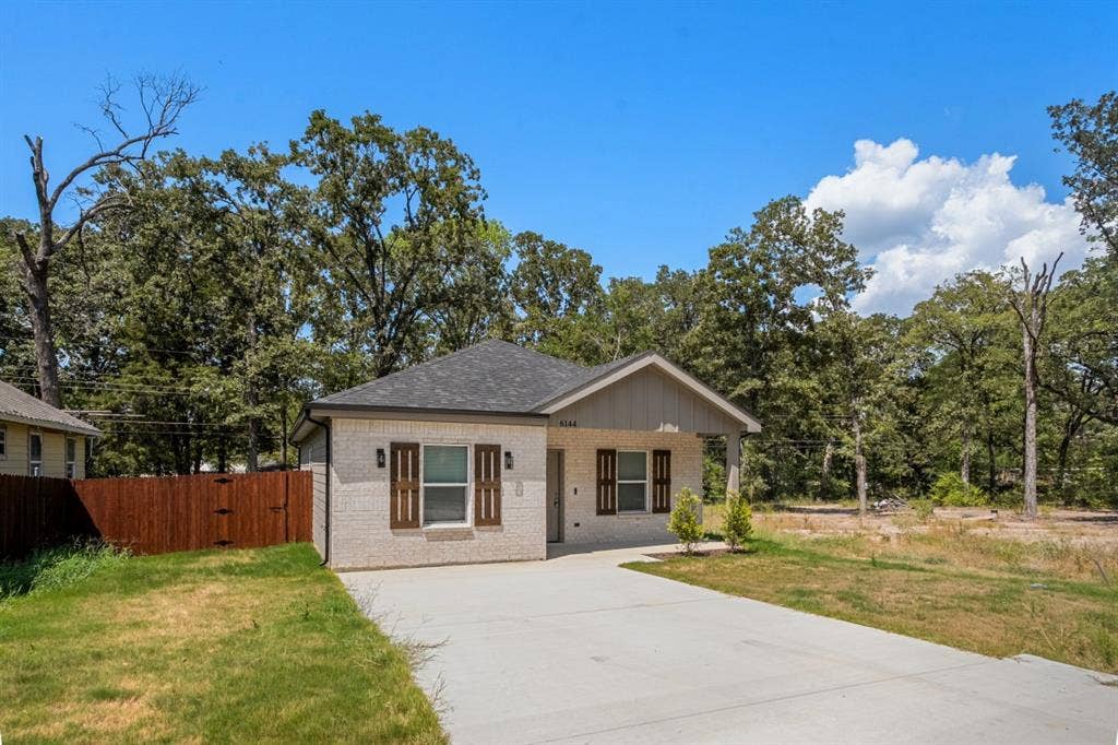 6144 Shawnee Drive, Mabank, TX 75156 Single-story exterior featuring light-colored brick siding, decorative window shutters, a covered front entryway, and a concrete driveway
