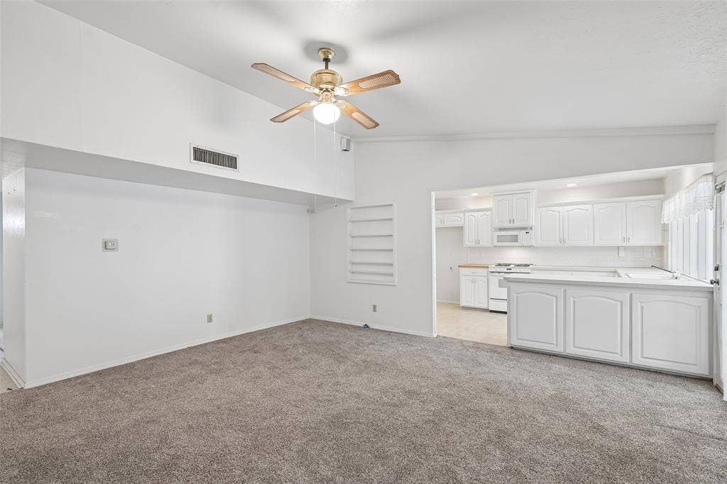 3309 S Edelweiss Drive, Grand Prairie, TX 75052 Vaulted ceilings carry from the living room straight into the kitchen.