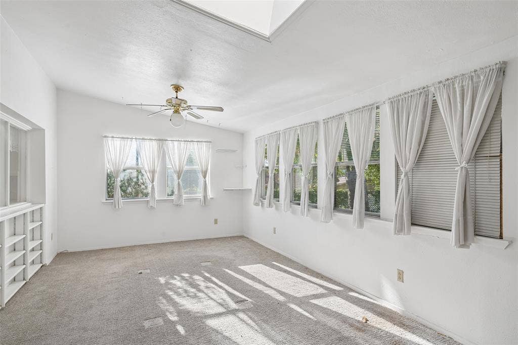 3309 S Edelweiss Drive, Grand Prairie, TX 75052 A wall of windows and a skylight fill the game room with light.
