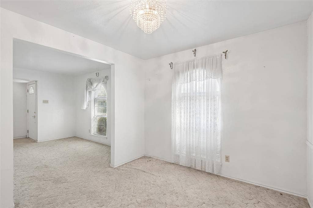 3309 S Edelweiss Drive, Grand Prairie, TX 75052 Arched-top window and chandelier light up the dining room.