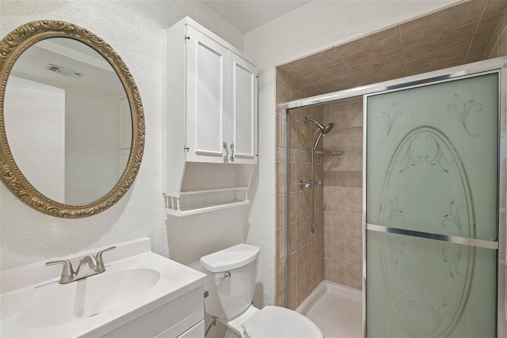 3309 S Edelweiss Drive, Grand Prairie, TX 75052 A walk-in shower with a glass door and a single vanity.