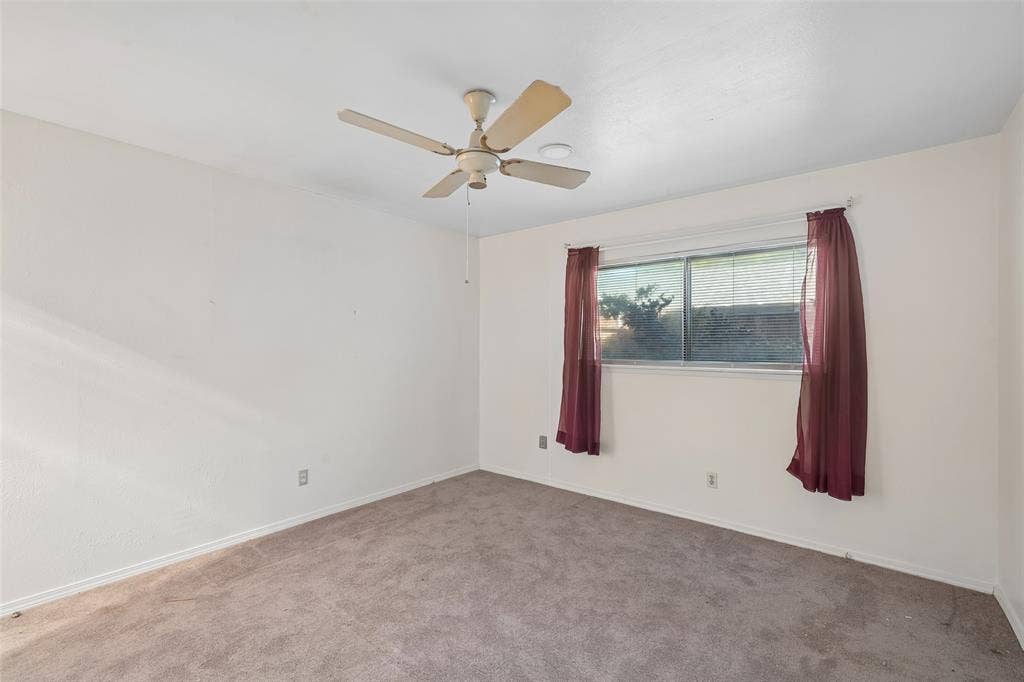 3309 S Edelweiss Drive, Grand Prairie, TX 75052 A bright bedroom with a ceiling fan.