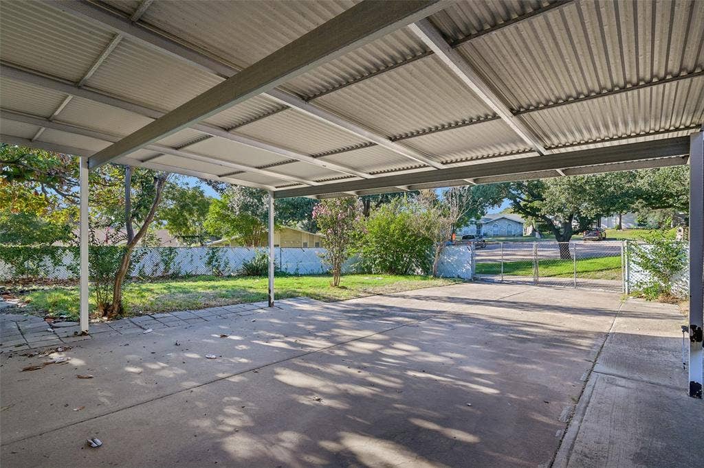 3309 S Edelweiss Drive, Grand Prairie, TX 75052 A covered patio looks out over the big corner-lot backyard.