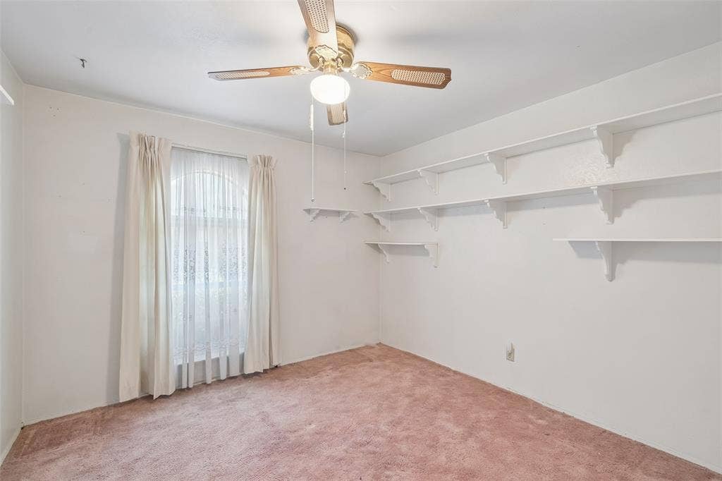 3309 S Edelweiss Drive, Grand Prairie, TX 75052 Ceiling fan and wall shelving in this bedroom.
