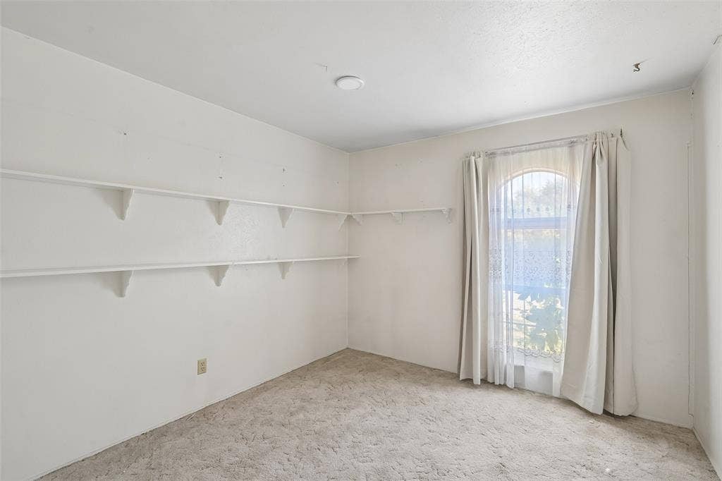 3309 S Edelweiss Drive, Grand Prairie, TX 75052 Shelving lines the walls of this bedroom.