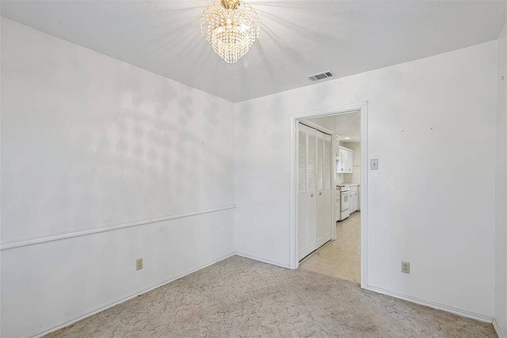 3309 S Edelweiss Drive, Grand Prairie, TX 75052 A separate dining room with a chandelier, just off the kitchen.
