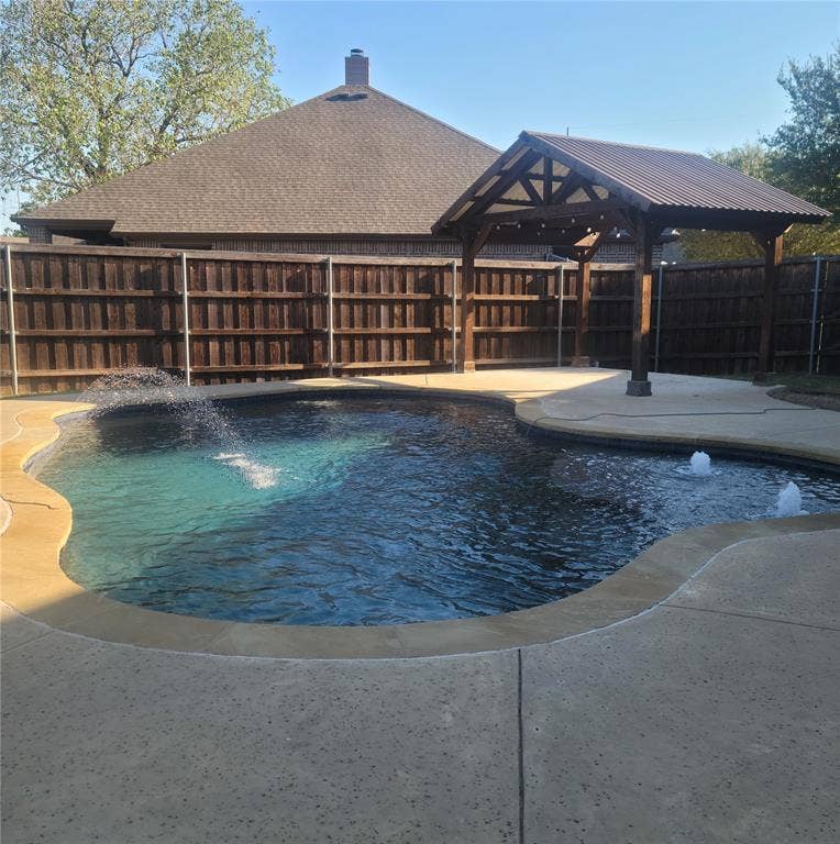 104 Aztec Court, Waxahachie, TX 75165 Pool with water features and covered sitting area.
