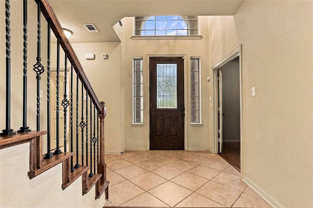 104 Aztec Court, Waxahachie, TX 75165 Entry with beautiful stair rail and designer front door.