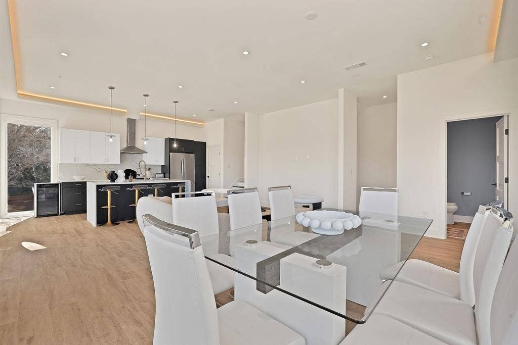 1731 N Fitzhugh Avenue, Dallas, TX 75204 Dining space featuring wine cooler, sink, and light hardwood / wood-style flooring