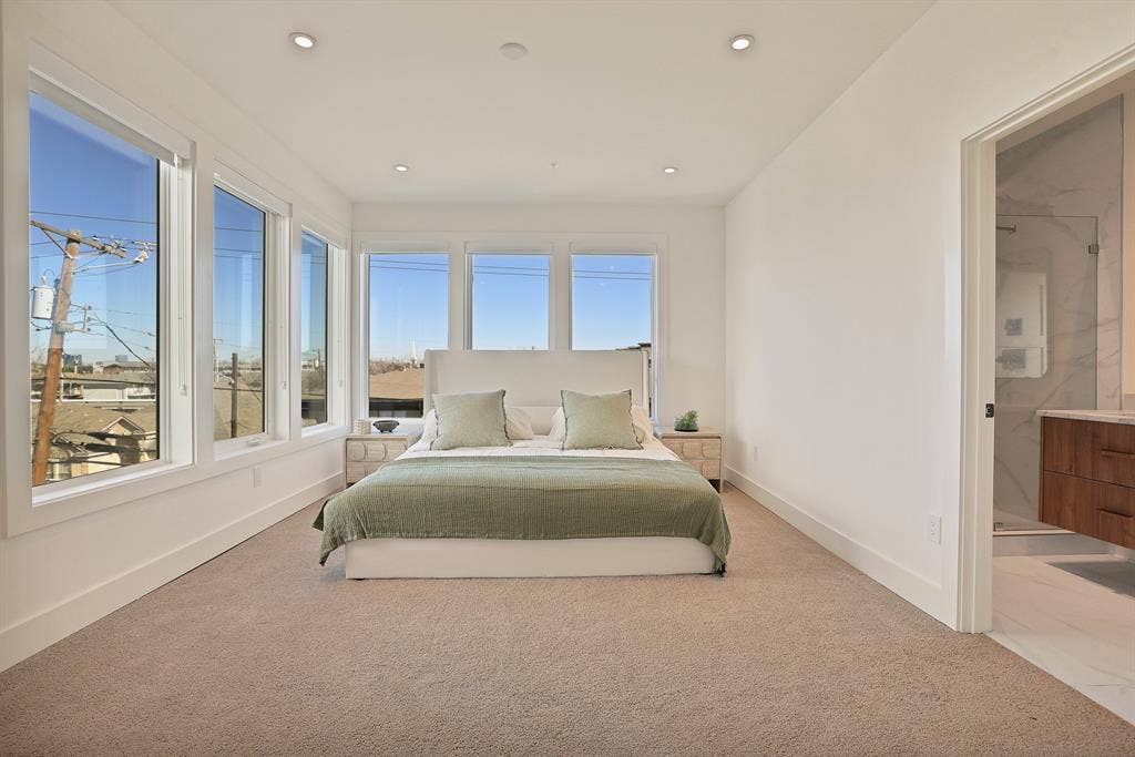 1731 N Fitzhugh Avenue, Dallas, TX 75204 Bedroom with ensuite bath and light carpet