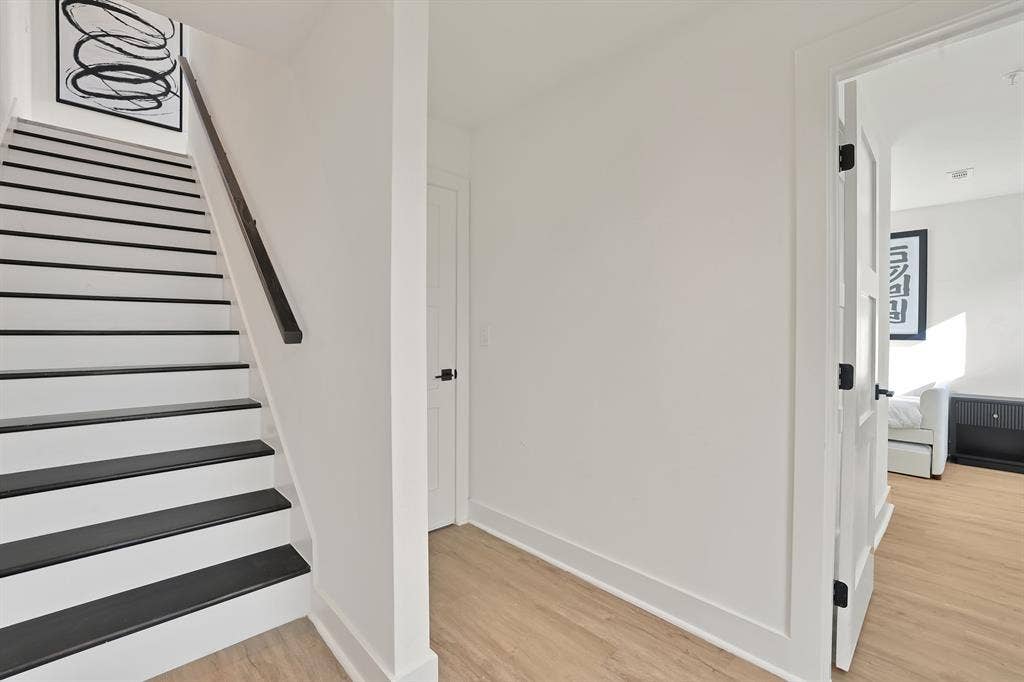 1731 N Fitzhugh Avenue, Dallas, TX 75204 Stairs featuring hardwood / wood-style flooring