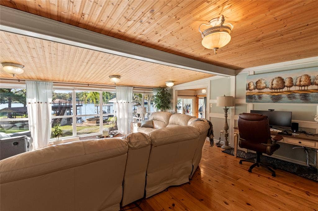 230 Bushwhacker Drive, Mabank, TX 75156 Tongue-and-groove wood-plank ceiling, extensive floor-to-ceiling windows, polished wood-finish flooring, and wall paneling