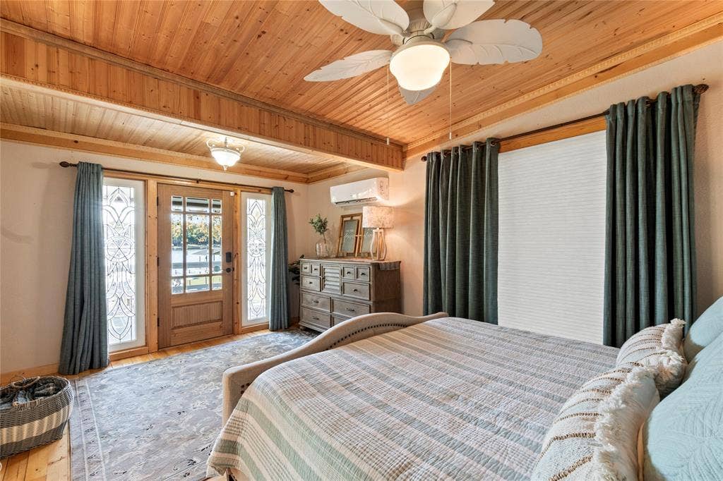 230 Bushwhacker Drive, Mabank, TX 75156 Wood-paneled ceiling, ceiling fan with integrated lighting, glass-paneled entry door with sidelights, and wall-mounted ductless climate control unit