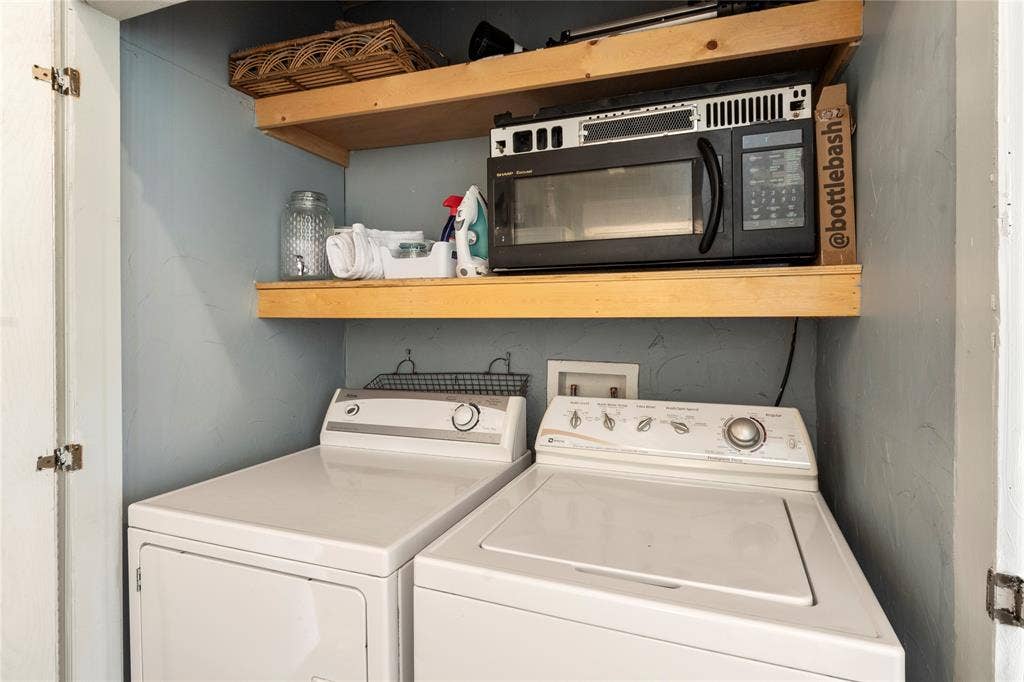 230 Bushwhacker Drive, Mabank, TX 75156 Utility space featuring dual wood shelving and built-in laundry hookups