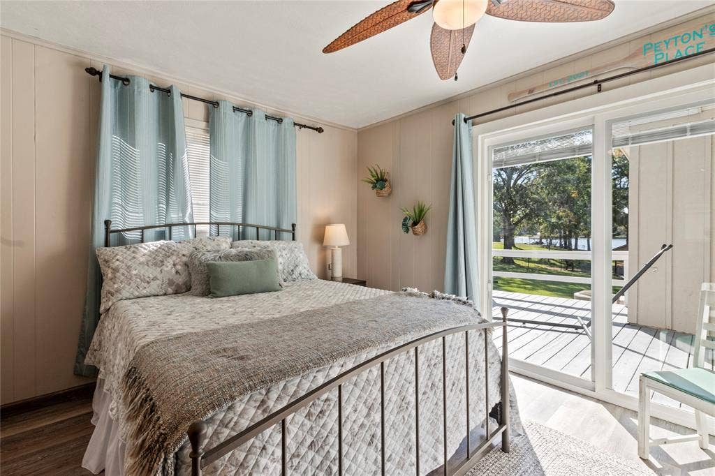 230 Bushwhacker Drive, Mabank, TX 75156 Sliding glass doors providing exterior access, wood-finish flooring, and a ceiling fan with integrated lighting