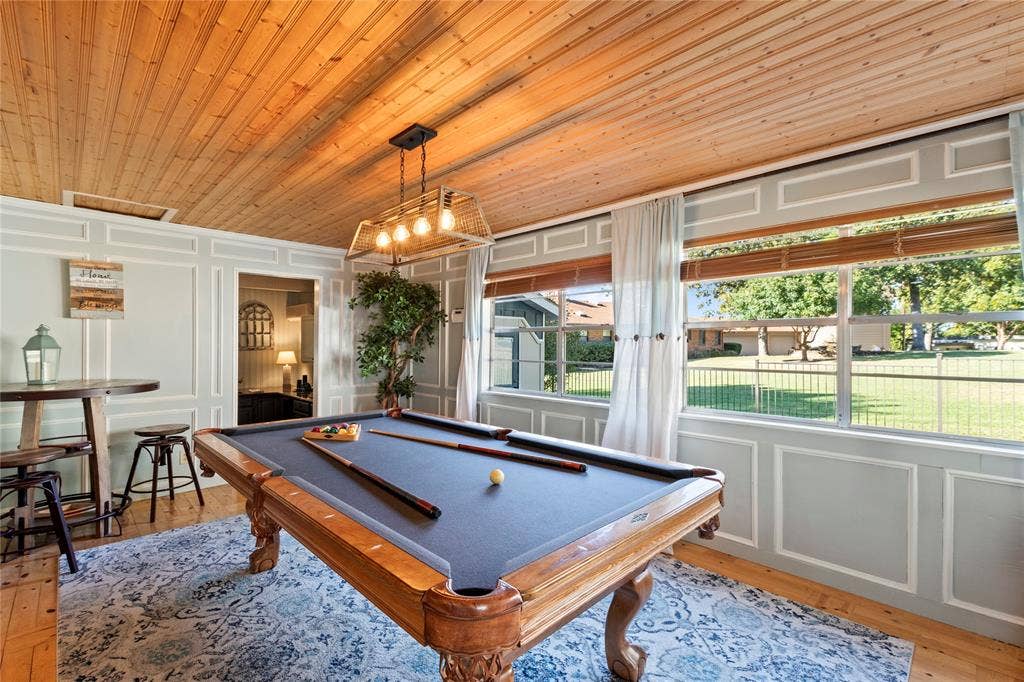 230 Bushwhacker Drive, Mabank, TX 75156 Beadboard wood-plank ceiling, wall wainscoting with decorative molding, large multi-pane windows, and a box-frame metal light fixture