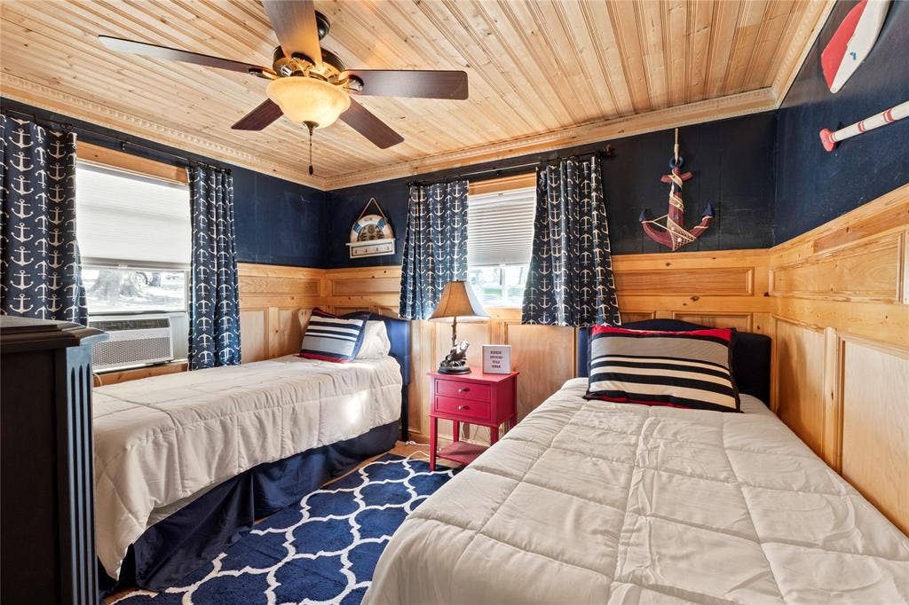 230 Bushwhacker Drive, Mabank, TX 75156 Room featuring natural wood plank ceiling, wood panel wainscoting, and a multi-blade ceiling fan