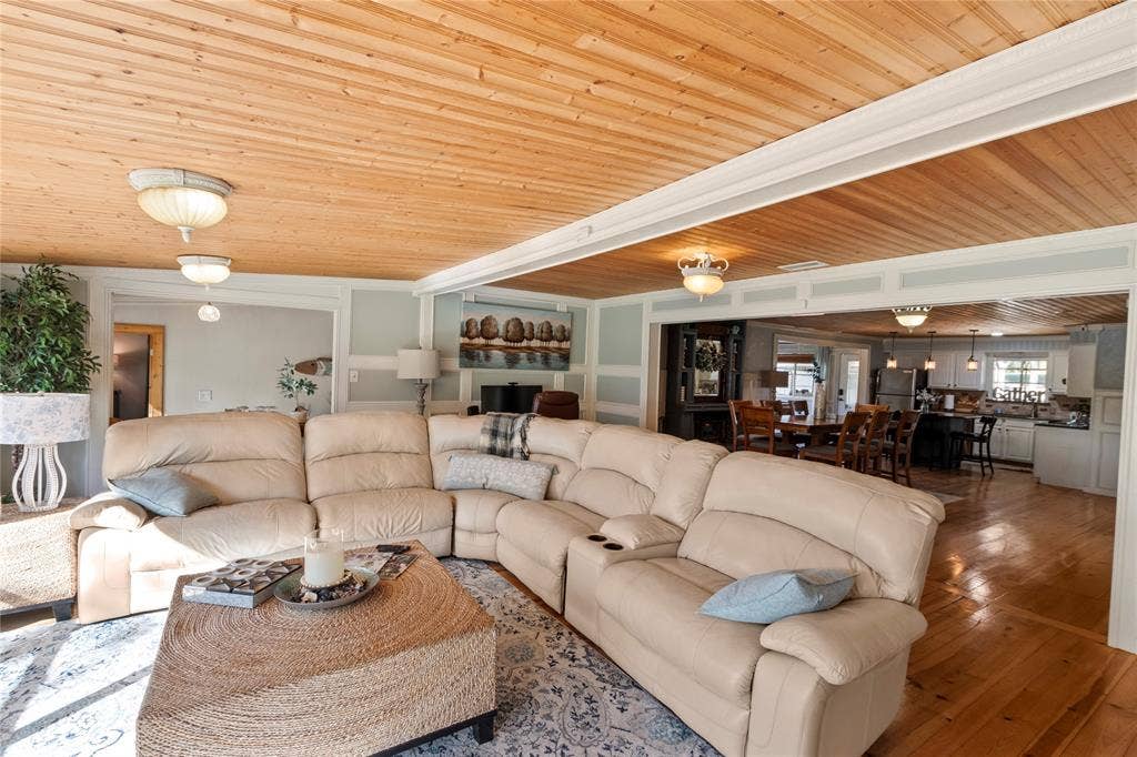 230 Bushwhacker Drive, Mabank, TX 75156 Natural wood-plank ceiling, wide-plank wood flooring, and wainscot wall paneling