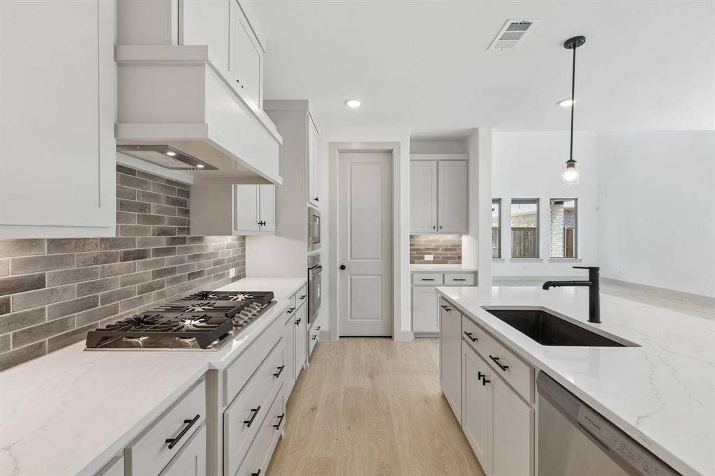 Gorgeous cabinetry, beautiful counter tops and contemporary stainless steel come together to create a chefs dream kitchen!
