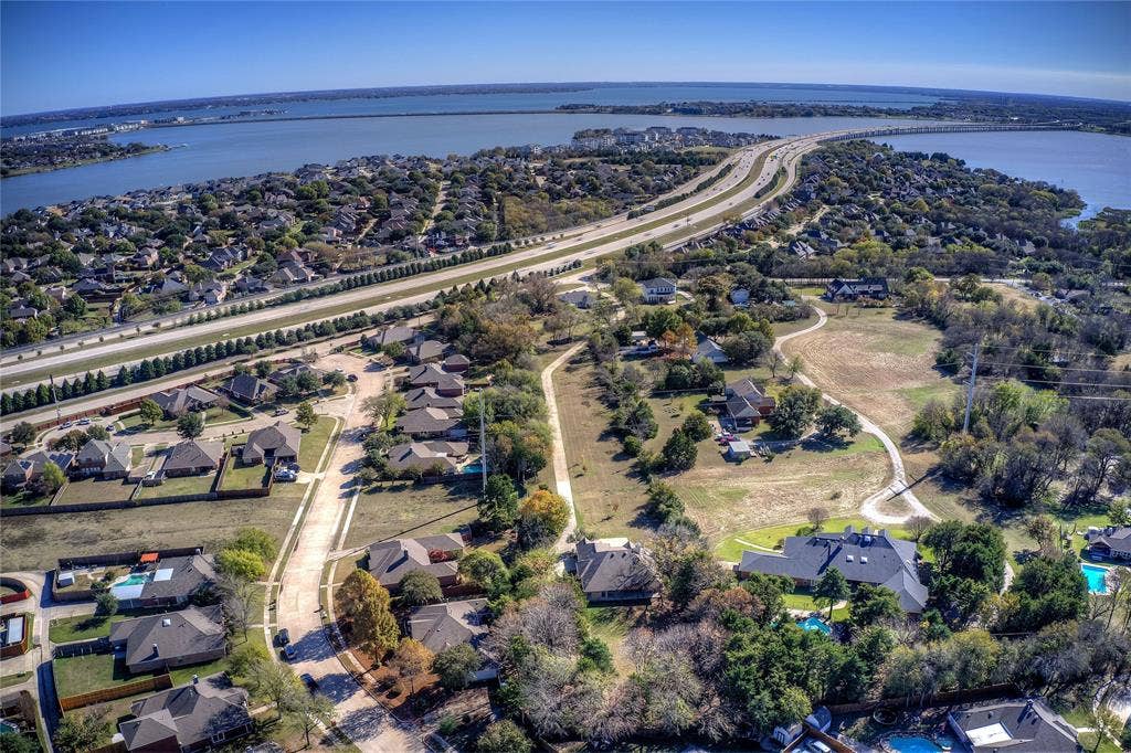 Aerial view of property's location with nearby suburban area and a large body of water