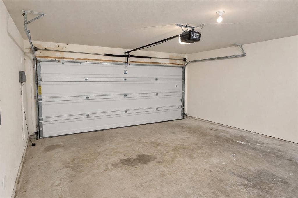 Multi-car garage featuring a sectional metal door and automated opener