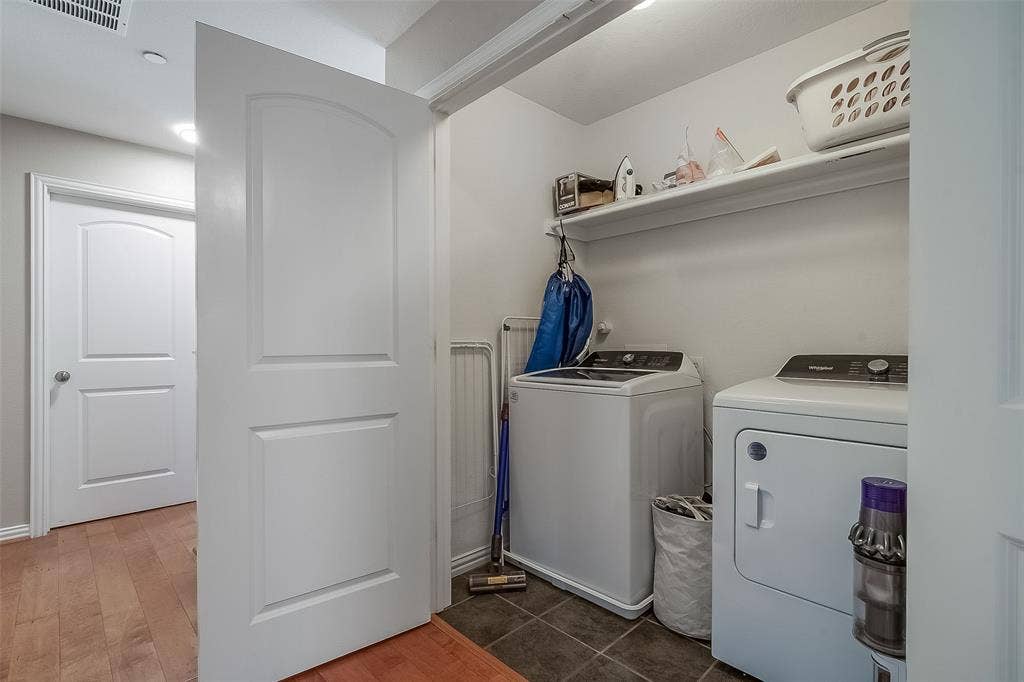 Laundry room featuring ceramic tile flooring, a dedicated built-in storage shelf, and wood-finish interior doors