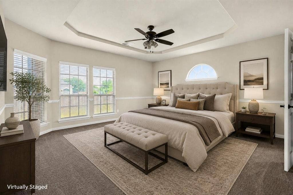 206 White Rock Court, Ovilla, TX 75154 Tray ceiling with central ceiling fan, multiple windows with grid detailing, and arched accent window